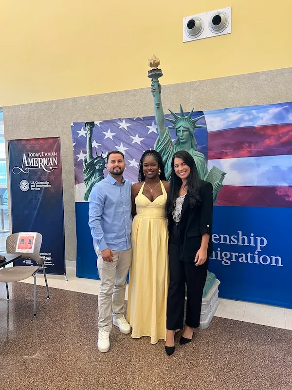 Clients celebrating a successful naturalization at a USCIS ceremony