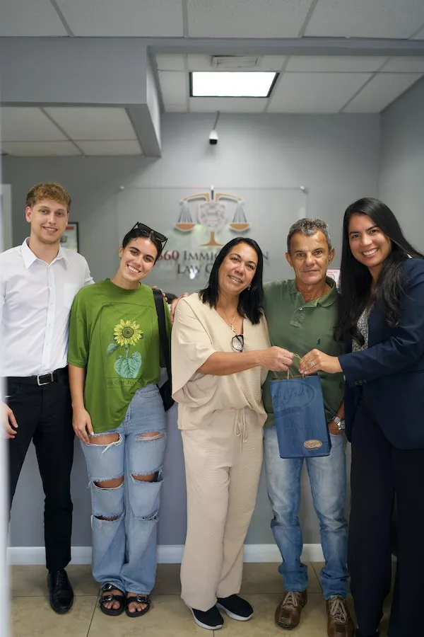 Family receiving a celebratory gift after an approved immigration case