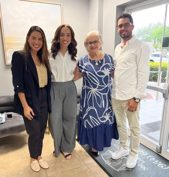 Clients celebrating an approved case with family at the 360 Immigration Law Group office